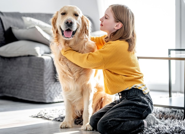 Preteen girl with golden retriever dog