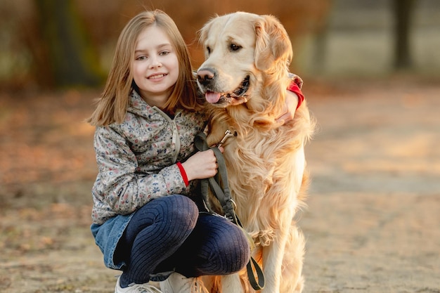 Preteen girl with golden retriever dog