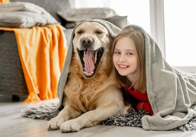 Preteen girl with golden retriever dog