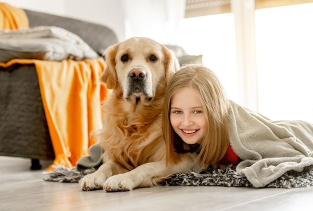 Preteen girl with golden retriever dog