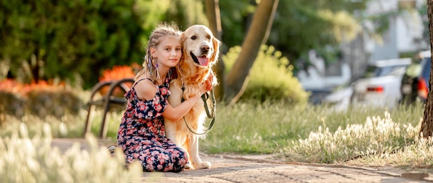 Preteen girl with golden retriever dog