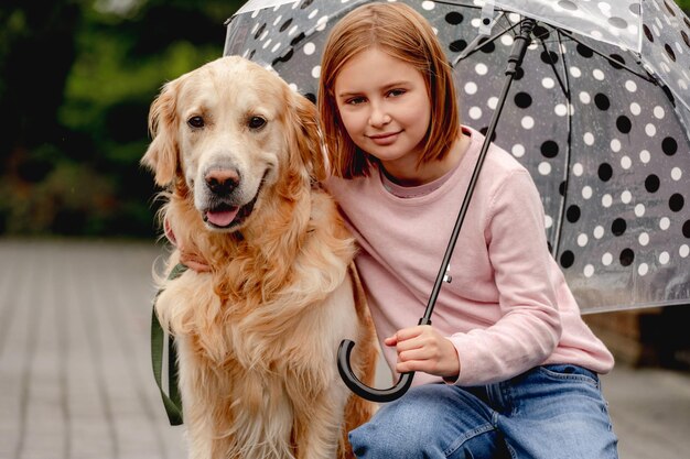 Preteen girl with golden retriever dog