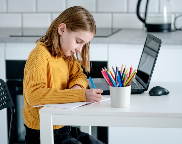 Preteen girl with laptop