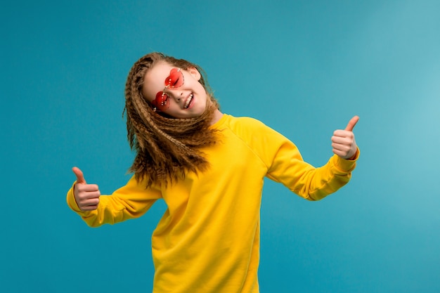 Preteen girl in yellow clothes smiling