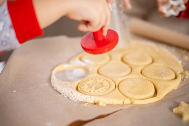 Prettige kerstdagen en prettige feestdagen. Kerstkoekjes close-up proces koken. Moeder kookt met de kinderen. Hoge kwaliteit foto