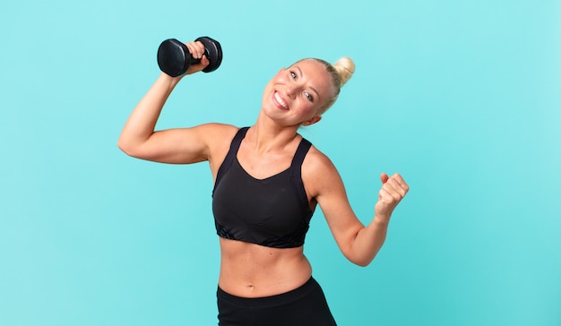 Pretty adult woman with a dumbbell