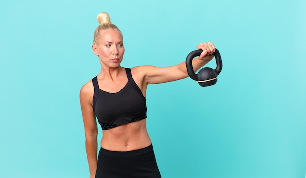 Pretty adult woman with a dumbbell