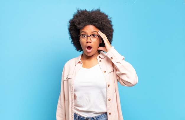 pretty african American woman against isolated wall