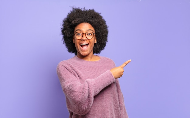 pretty african American woman against isolated wall