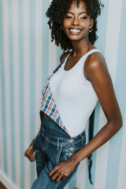 Pretty African American woman posing in jeans trousers