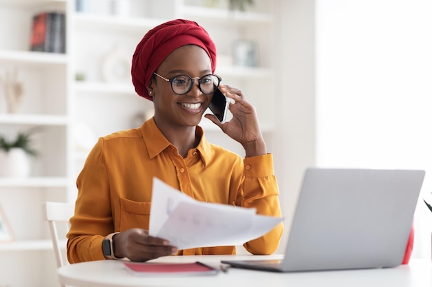 Pretty african american woman in turban working from home