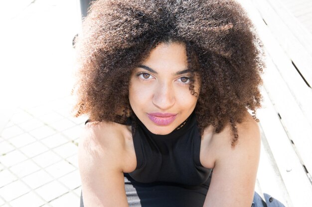 Pretty african mixed woman with curly hairs