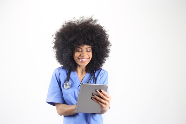 Pretty afro american female doctor, with a tablet, white background