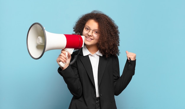 Pretty afro teenager business girl with a megaphone