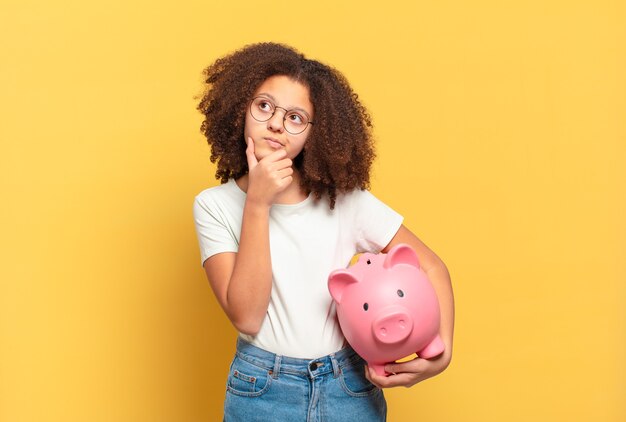 Pretty afro teenager looking desperate and frustrated, stressed, unhappy and annoyed, shouting and screaming. savings concept