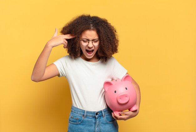 Pretty afro teenager smiling and looking friendly, showing number three or third with hand forward, counting down. savings concept