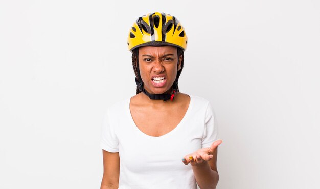 Pretty afro woman with braids with a bike helmet