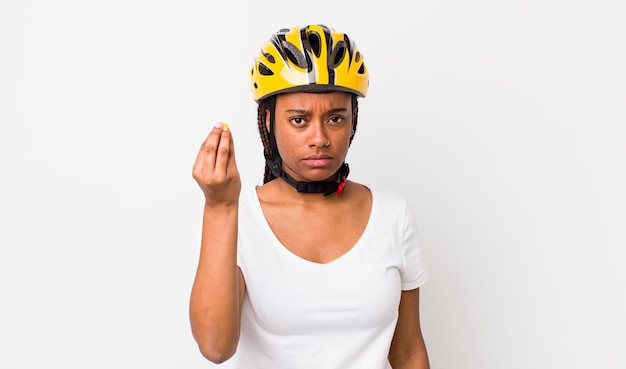 Pretty afro woman with braids with a bike helmet