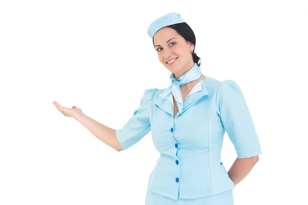 Pretty air hostess presenting with hand