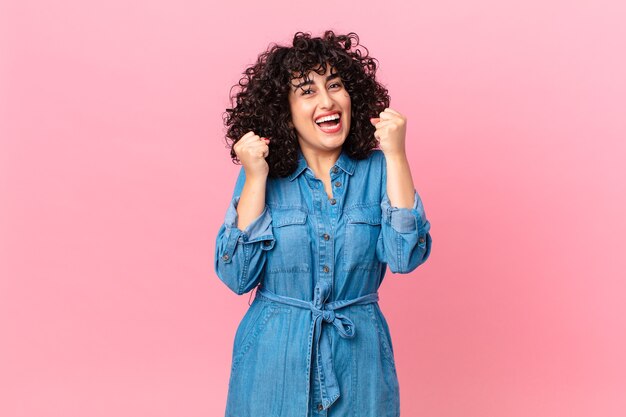 Pretty arab woman feeling shocked,laughing and celebrating success