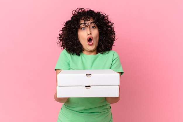 Pretty arab woman holding a pizza box