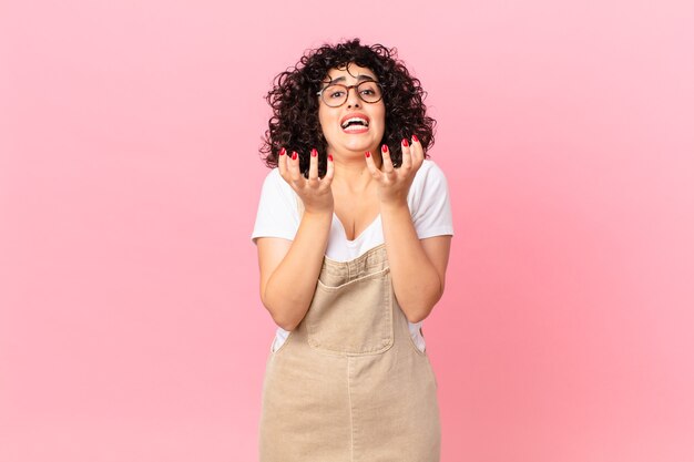 Pretty arab woman looking desperate, frustrated and stressed