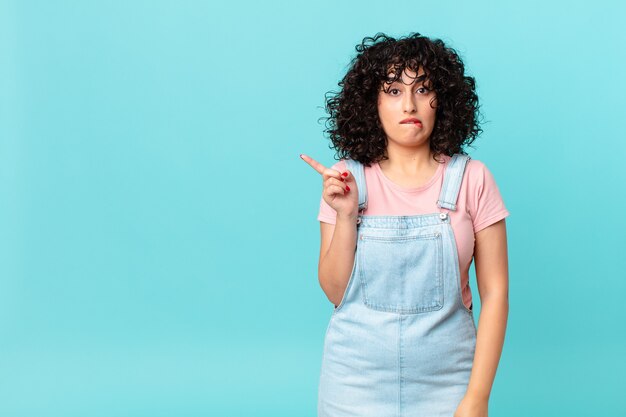 Pretty arab woman looking puzzled and confused