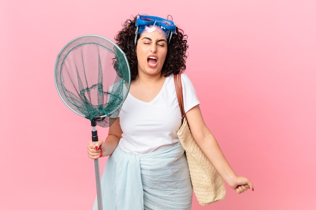 Pretty arab woman shouting aggressively, looking very angry with goggles. fisher concept