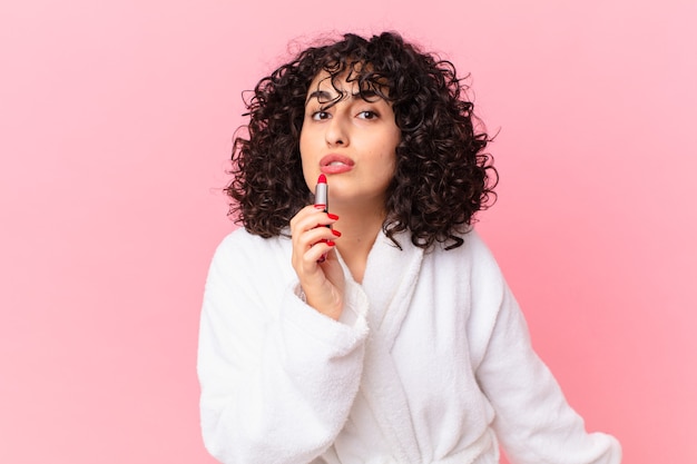 Pretty arab woman wearing bathrobe and a lipstick