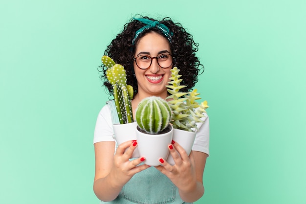 Photo pretty arab woman with decorative potted cactus