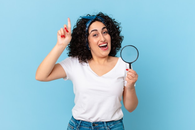 Pretty arab woman with a magnifying glass