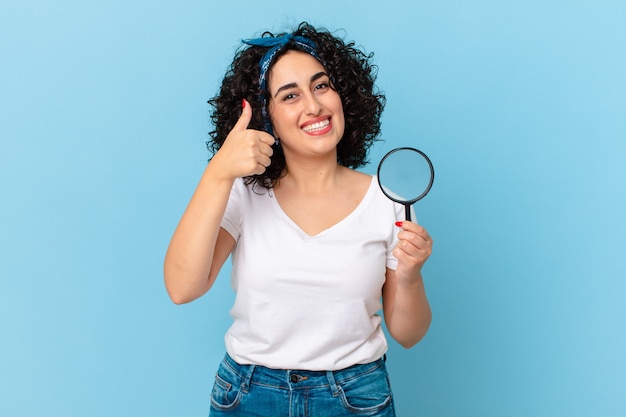 Pretty arab woman with a magnifying glass