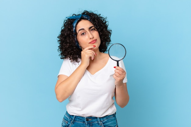 Pretty arab woman with a magnifying glass