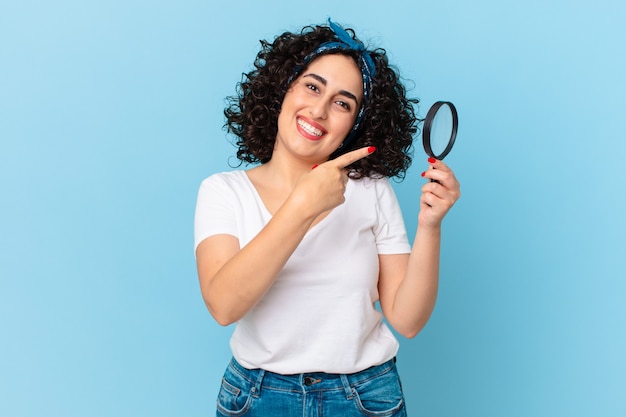 Pretty arab woman with a magnifying glass