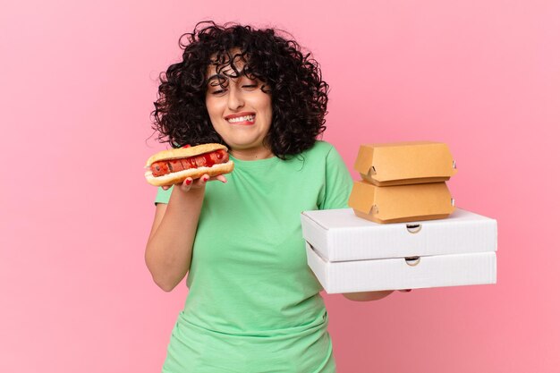 Pretty arab woman with take away fast food boxes