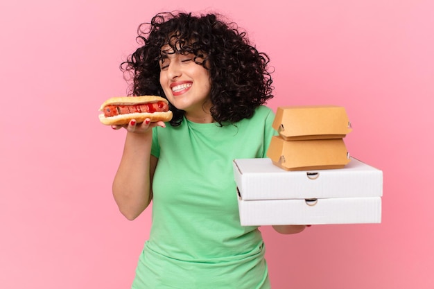 Pretty arab woman with take away fast food boxes