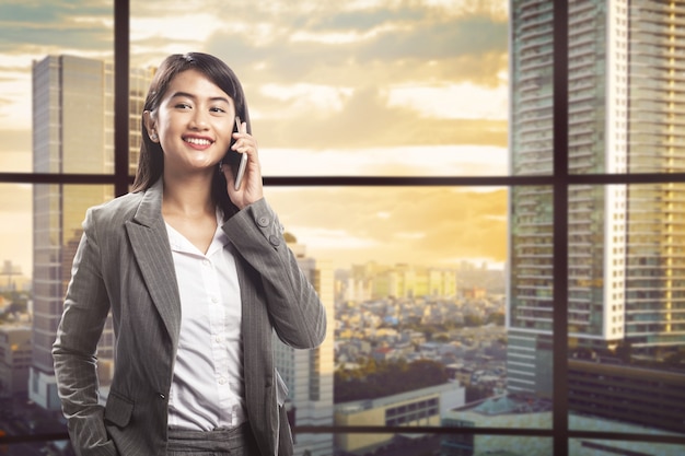 Pretty asian businesswoman talking on smartphone