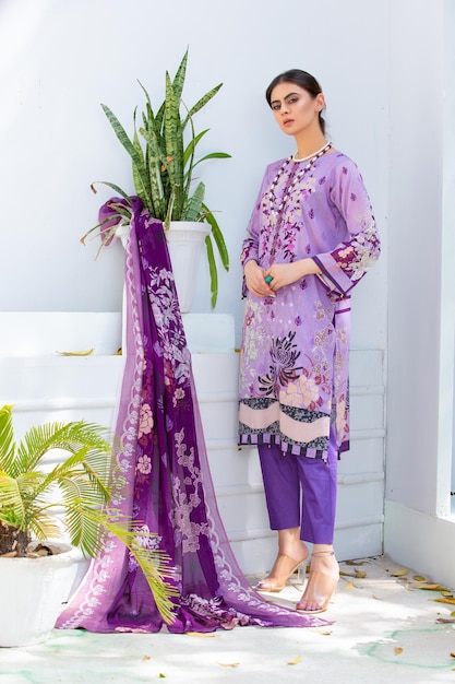 Pretty Asian Girl Standing With Plant Wearing Traditional Dress and Jewelry for Fashion Photoshoot