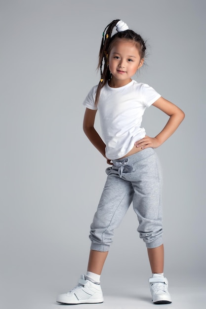 Pretty asian little girl in sportswear