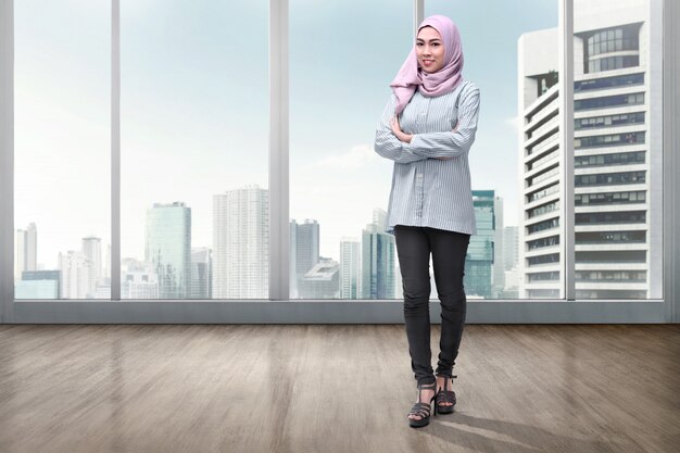 Pretty asian muslim woman in veil with arms crossed