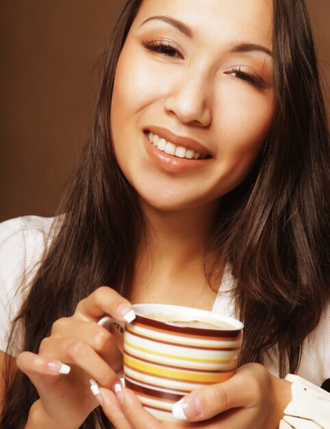 Pretty asian woman drinking coffee