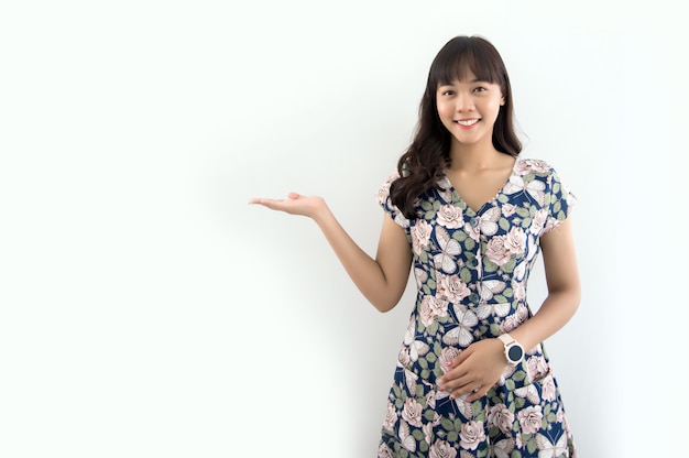 Pretty asian woman open hand to present product on white isolated background (include path)