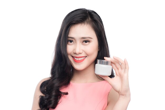 Pretty asian young woman holding moisturize jar