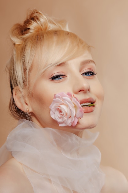 Pretty attractive girl with blond hair, fashion shooting, rose, 