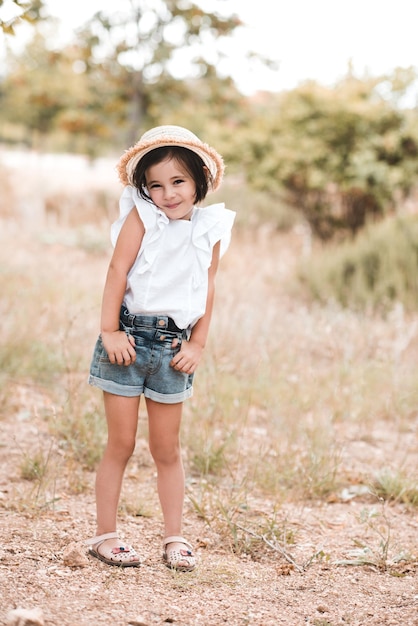 Pretty baby girl 34 year old posing in park outdoors Looking at camera Childhood