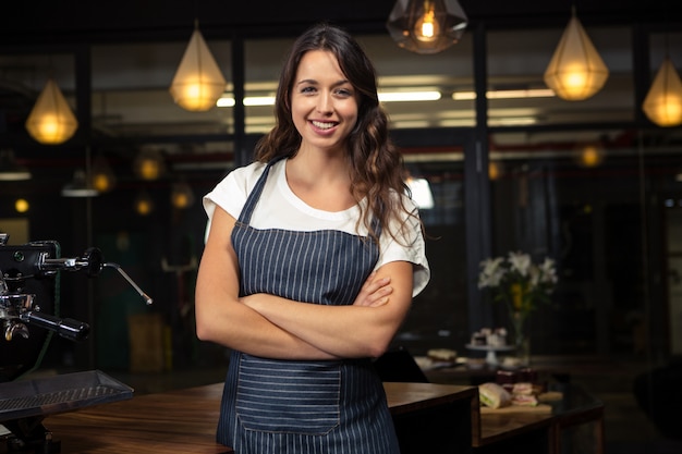 Pretty barista crossing arms