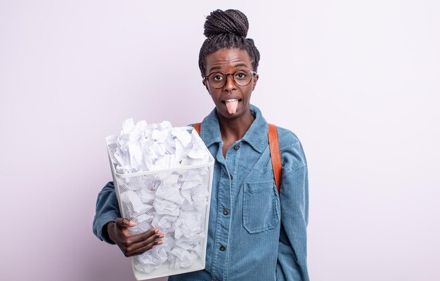 pretty black woman feeling disgusted and irritated and tongue out. paper balls failure concept