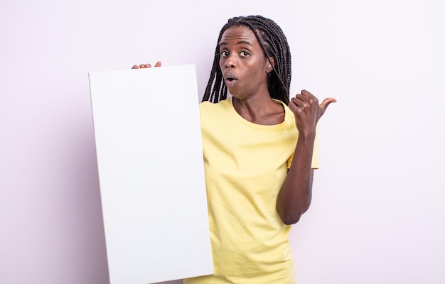 Pretty black woman looking astonished in disbelief. blank canvas concept