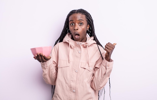 Pretty black woman looking astonished in disbelief. empty bowl concept