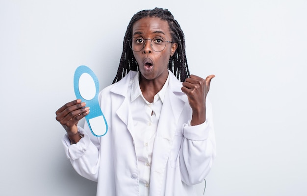Pretty black woman looking astonished in disbelief. podiatrist concept